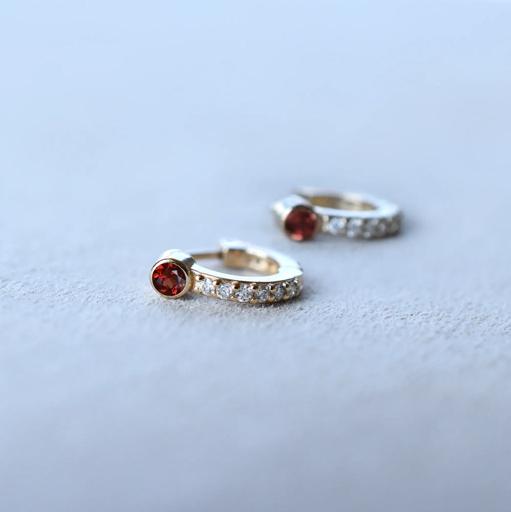 Tiny Garnet Huggie Hoops with Diamonds in 14k Gold (January)