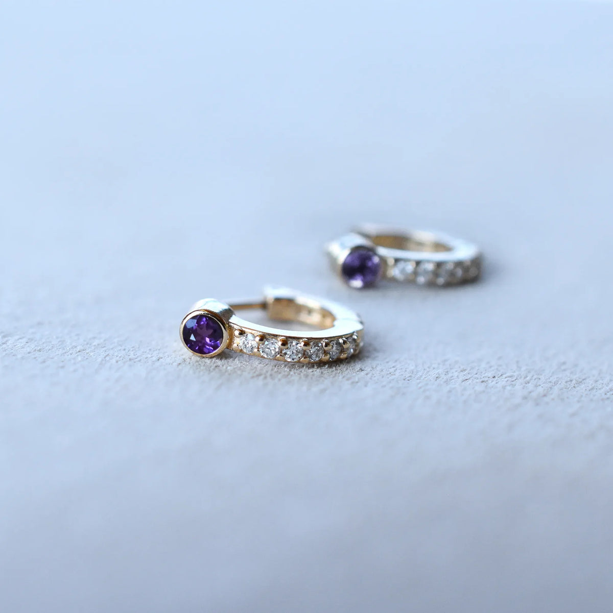 Tiny Amethyst Huggie Hoops with Diamonds in 14k Gold (February)