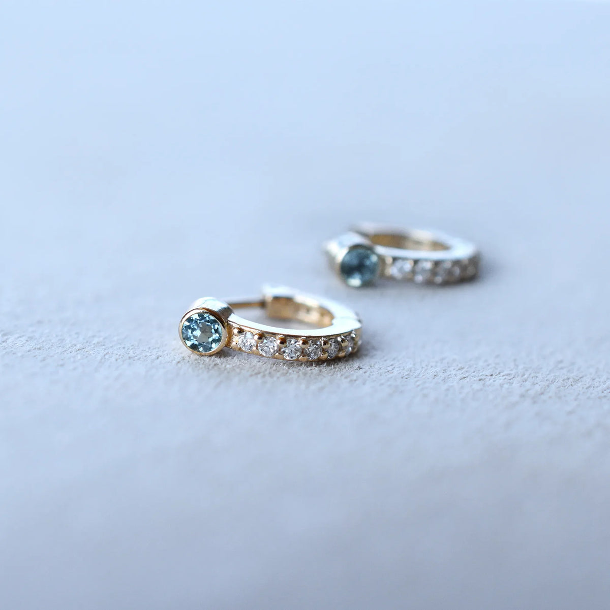 Tiny Nantucket Blue Topaz Huggie Hoops with Diamonds in 14k Gold (December)