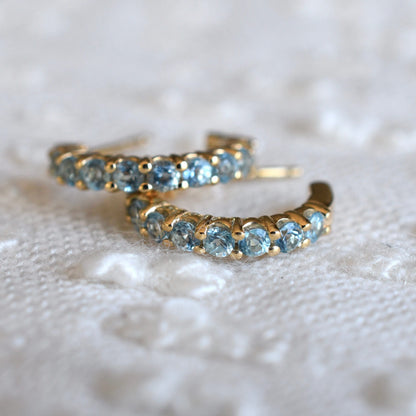 Rosecliff Nantucket Blue Topaz Huggie Hoop Earrings in 14k Gold (December)